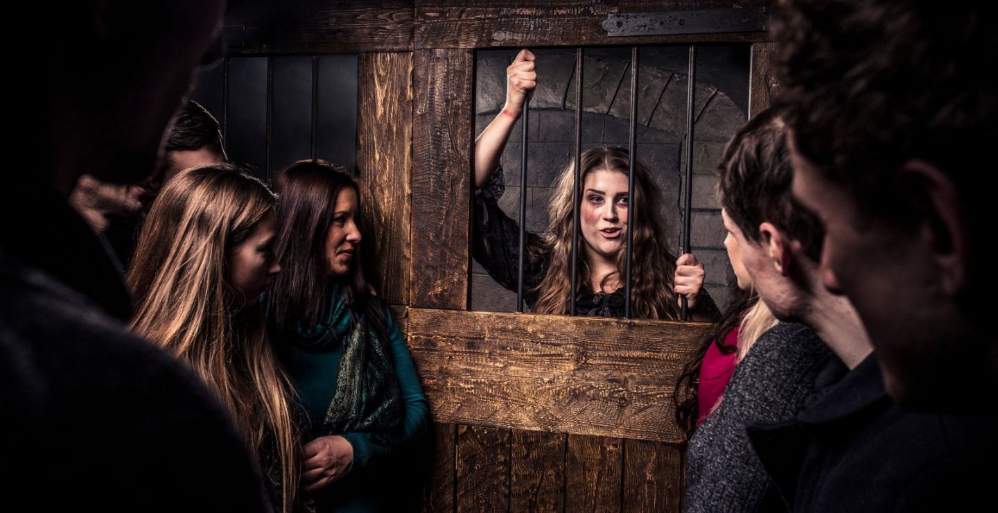 An Actor Talks to Guests From Behind Bars In The London Dungeons